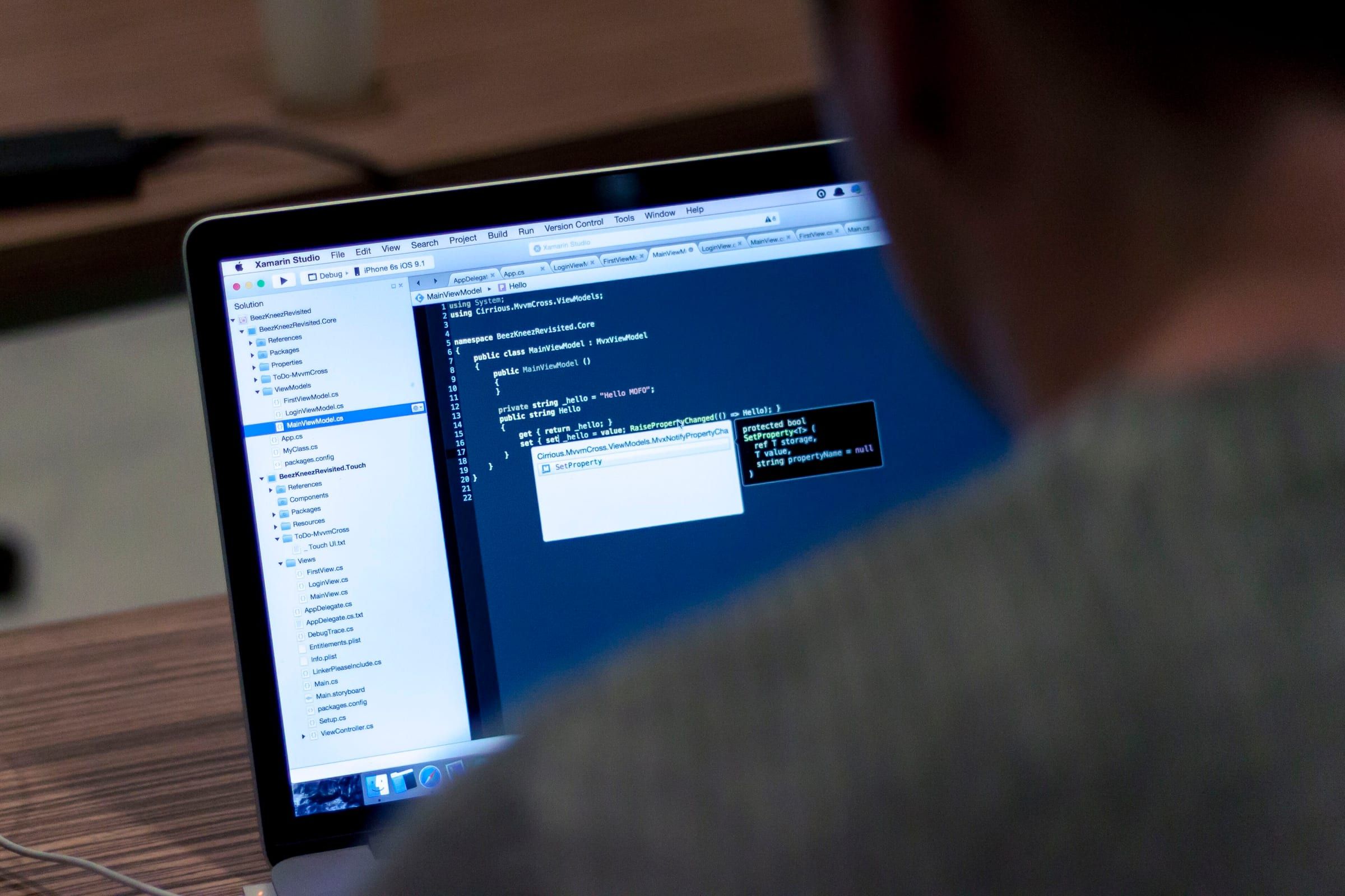 Developer writing code on a laptop